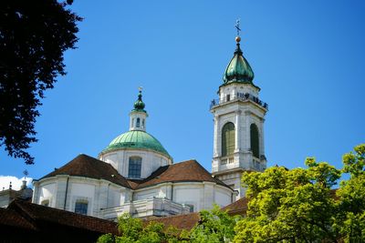 Low angle view of solothurn cathedral against clear blue sky