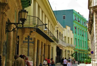 People on street amidst buildings in city