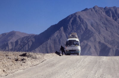 Car on mountain road against clear sky