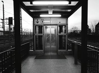 Closed door at railroad station against sky during sunset