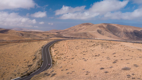 Scenic view of arid landscape against sky