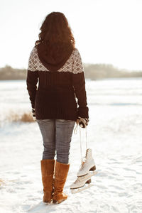 Woman standing on snow covered field