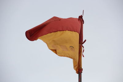 Low angle view of flag against clear sky