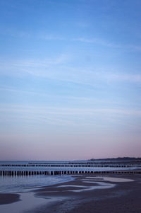 Scenic view of land against sky during sunset