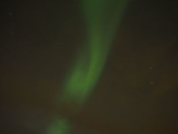 Low angle view of aurora borealis against star field