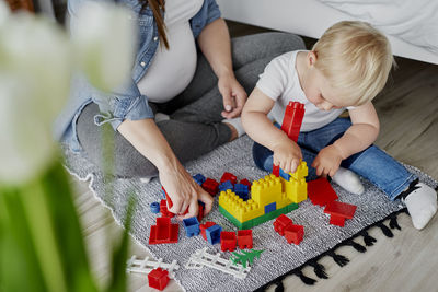 High angle view of friends playing with toy