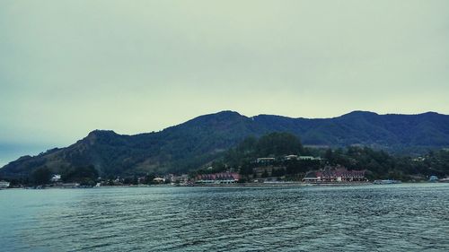 View of calm sea with mountain range in background