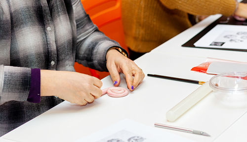 Midsection of man working on table