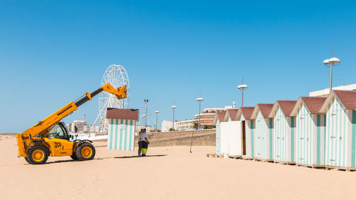 Built structure on beach against clear blue sky