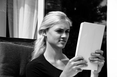 Beautiful young woman holding digital tablet