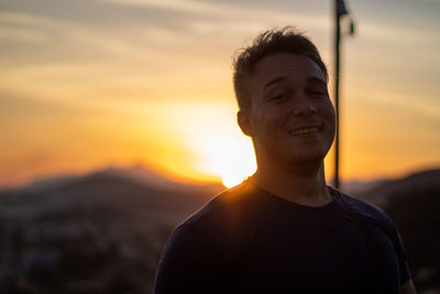 Portrait of young man against sky during sunset
