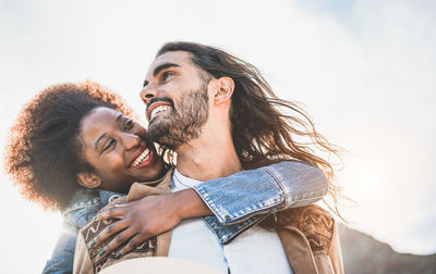 Low angle view of smiling young couple