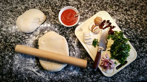 High angle view of pizza ingredients on table