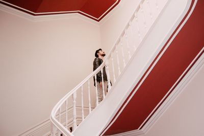 Low angle view of woman standing on staircase