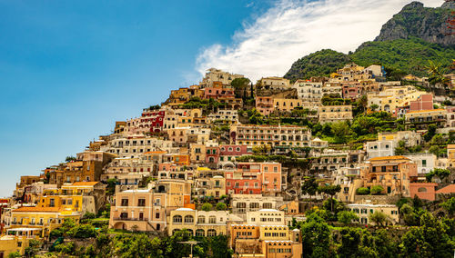 Colorful old buildings in town amalfi coast against sky