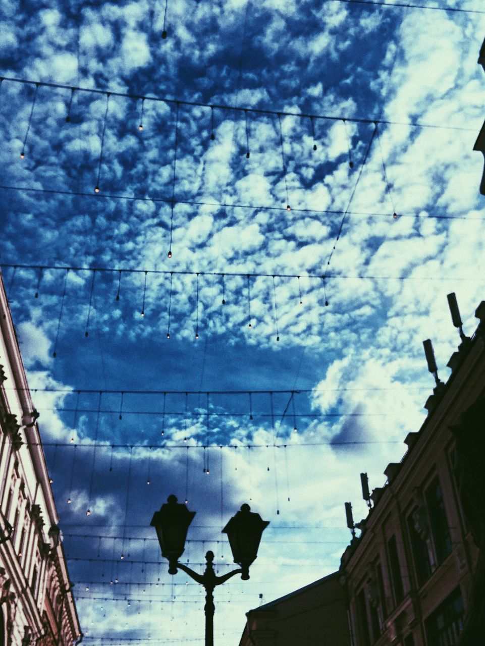 LOW ANGLE VIEW OF HOUSES AND STREET AGAINST SKY