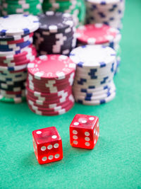 High angle view of gambling chips and dices on casino table