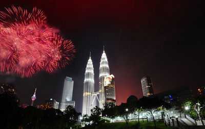 Firework display over city at night