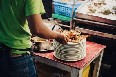 Midsection of man preparing food