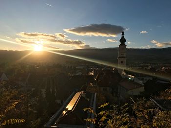 Aerial view of buildings in city at sunset