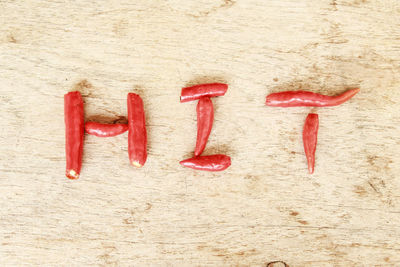 High angle view of red chili peppers arranged as text on table
