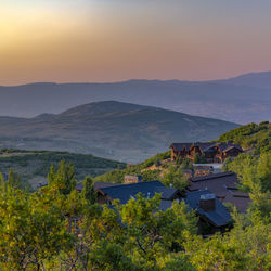 Scenic view of landscape and mountains against sky during sunset