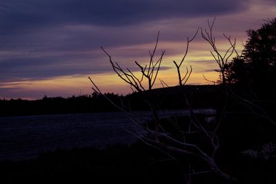 Scenic view of lake against sky at sunset