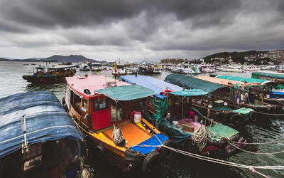 Boats moored at harbor in asia