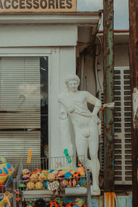Statue against building in city