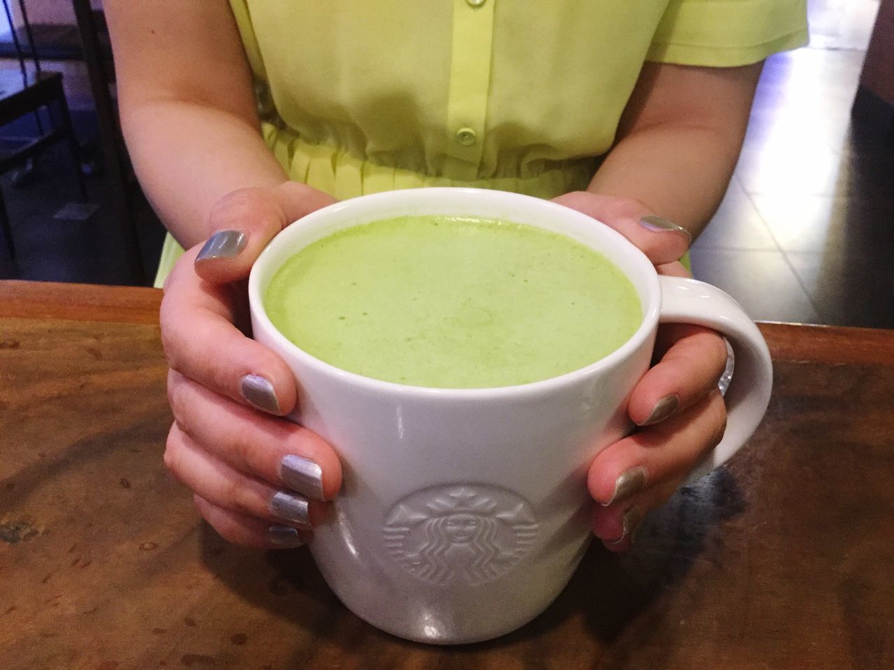 holding, food and drink, drink, one person, green tea, tea cup, human hand, tea - hot drink, women, one woman only, indoors, human body part, healthy eating, adults only, midsection, refreshment, close-up, only women, real people, adult, people, freshness, ready-to-eat, day