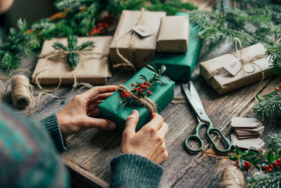 Midsection of woman holding christmas presents