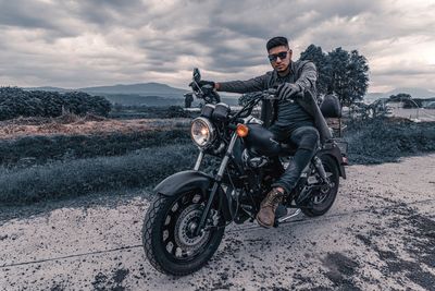 Man riding motorcycle on road