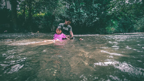 Full length of woman enjoying in water