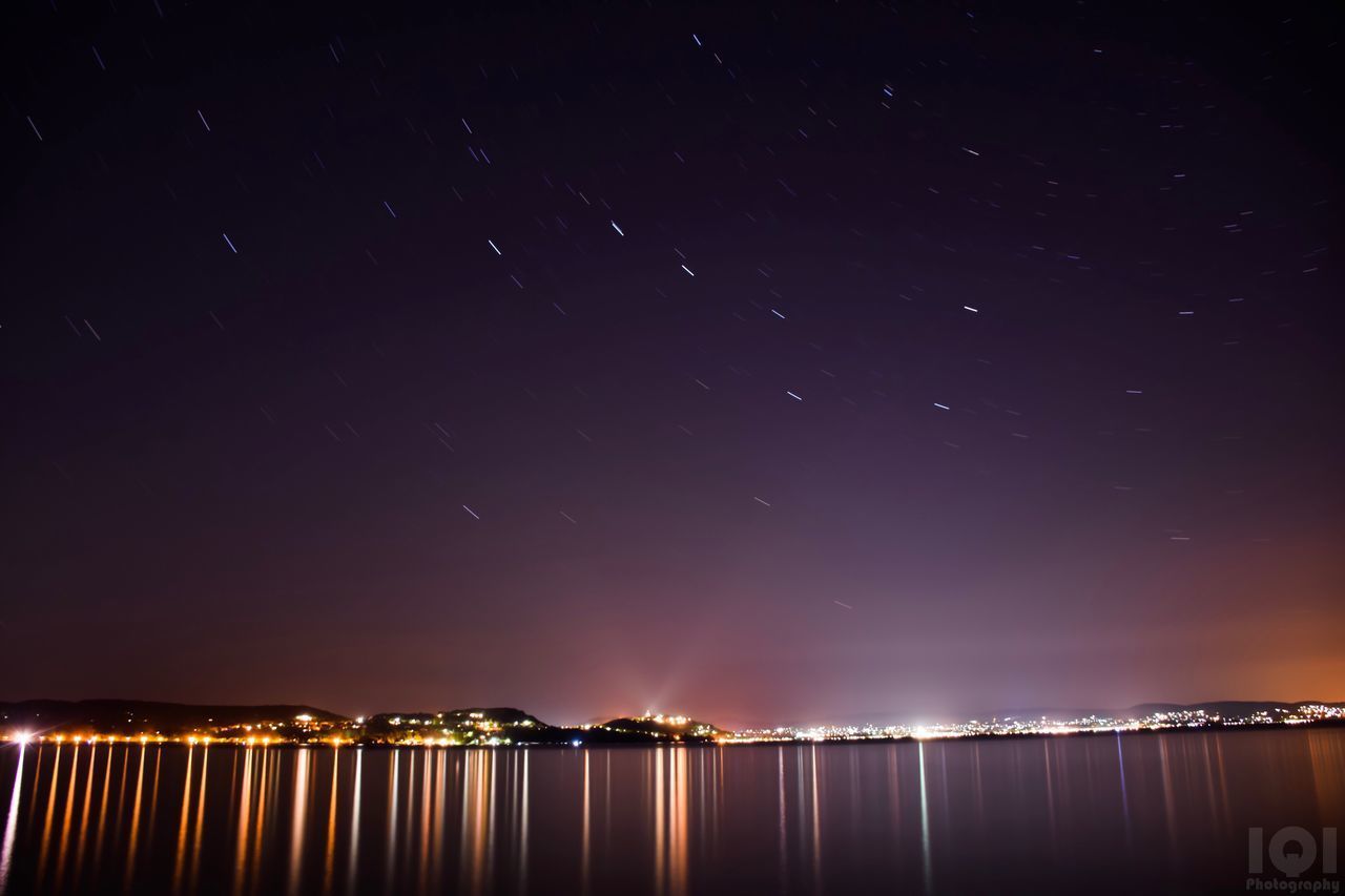 SCENIC VIEW OF ILLUMINATED STAR FIELD AGAINST SKY AT NIGHT