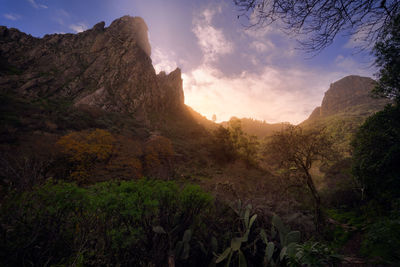 Scenic view of rocky mountains against sky during sunset