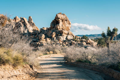 Rock formations on landscape against sky