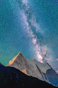 Low angle view of mountain against blue sky