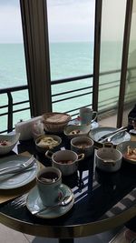 Close-up of food served on table by sea