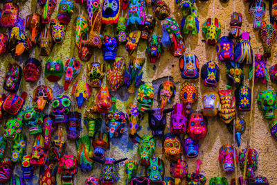 Full frame shot of colorful masks hanging on wall