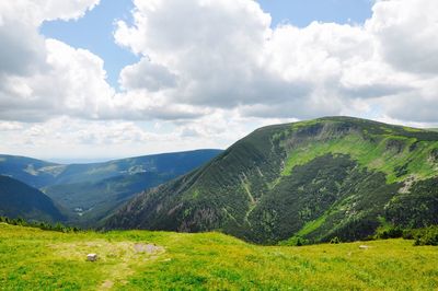 Scenic view of green mountains against sky