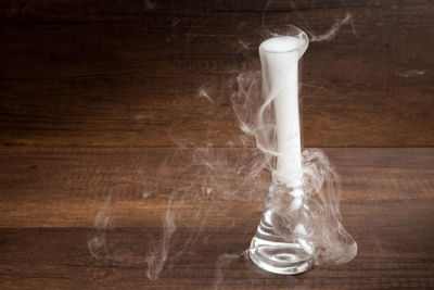 Drinking glass on table against white background