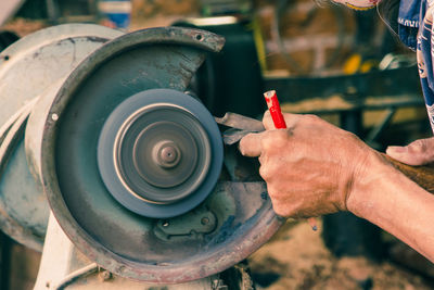 Close-up of man working on metal