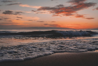 Scenic view of beach against sky during sunset