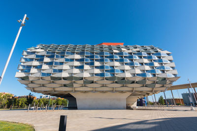 Low angle view of modern building against blue sky