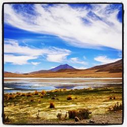 Scenic view of lake against cloudy sky