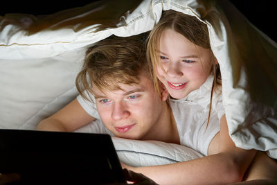 Siblings using laptop at home