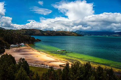 Scenic view of calm lake against blue sky