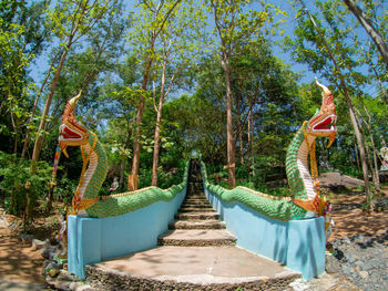 View of sculpture amidst trees in forest