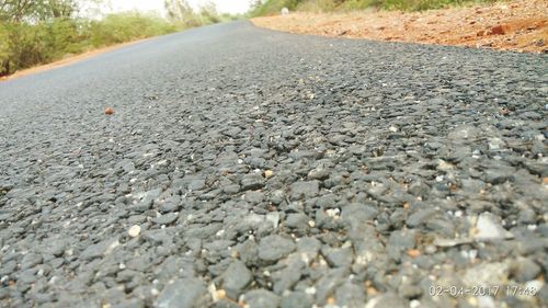 Close-up of pebbles on road