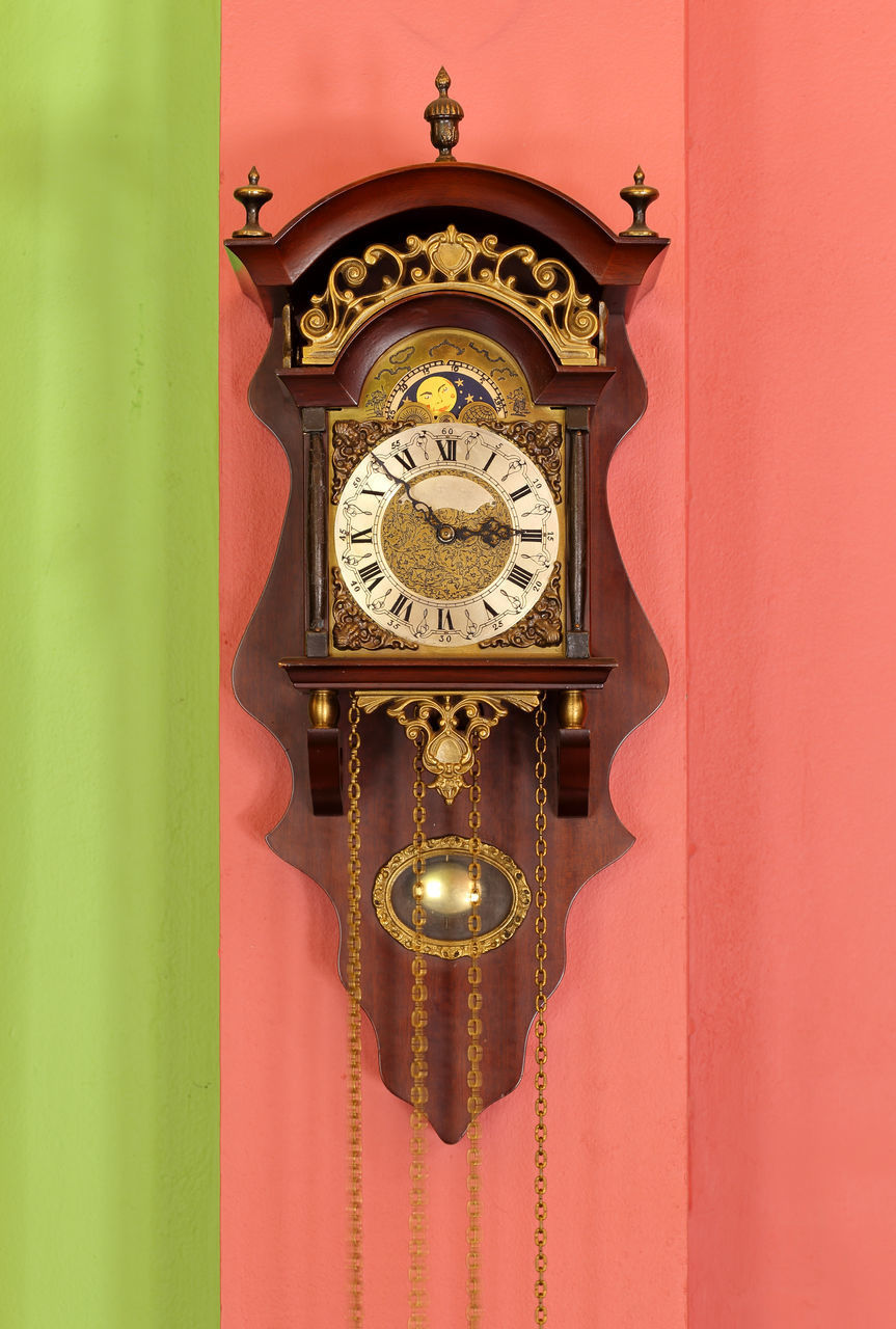 CLOSE-UP OF ILLUMINATED CLOCK ON WALL